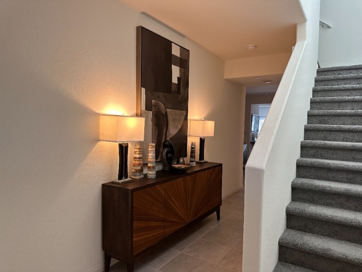 Hallway vignette with mid-century sideboard and abstract art