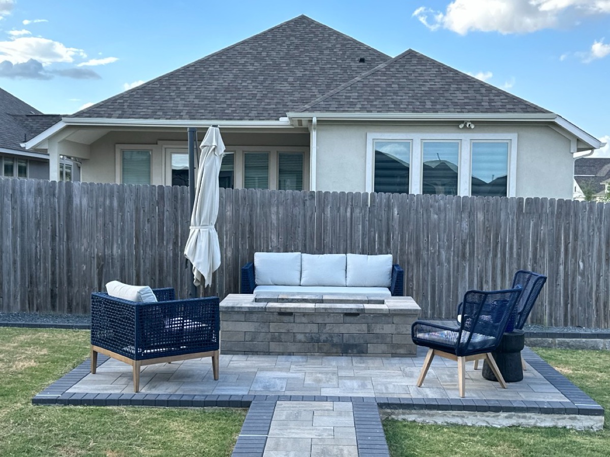 Back patio with stone fire pit and outdoor seating