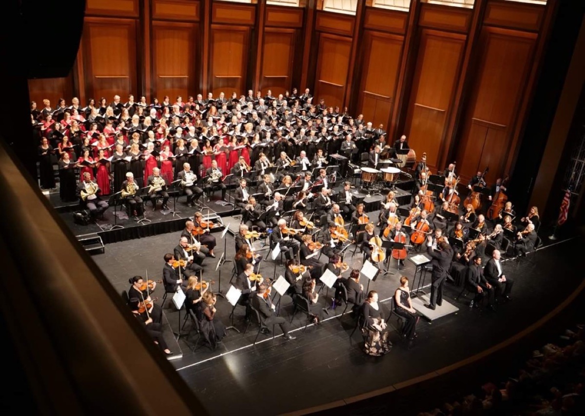 Choir and full orchestra on stage during a formal concert