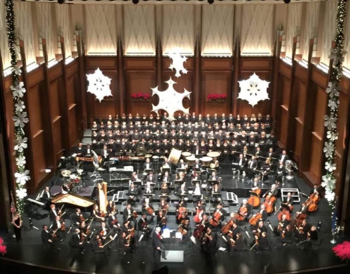 Holiday concert with choir, orchestra, and festive stage decor