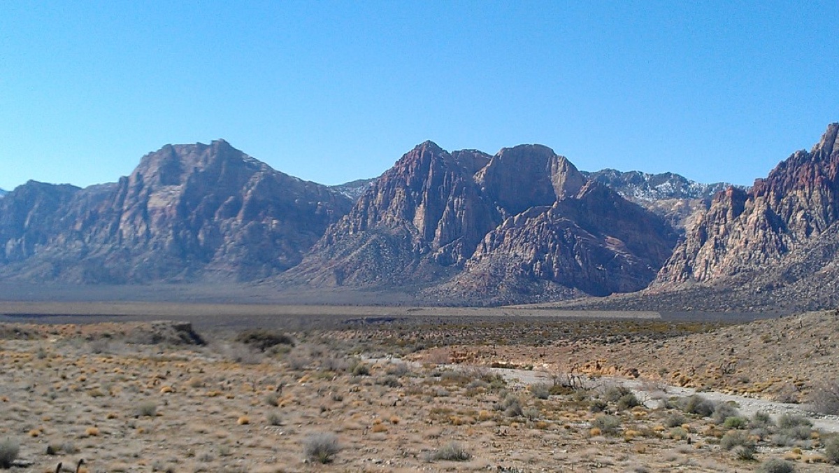 Red rock peaks and desert scrub on a clear day